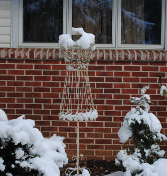 snow on a dress form making it look like a dress