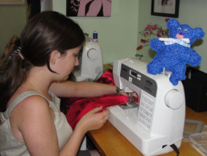 teen girl sewing at a sewing machine