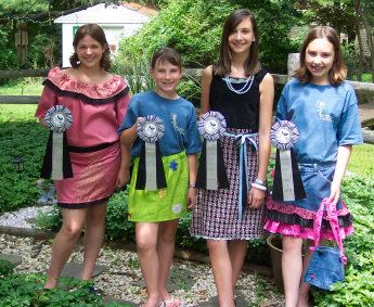 young girls showing awards they won for sewing their own clothes