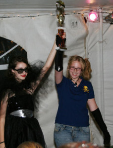 teen fashion designer and model holding a trophy at a fashion show