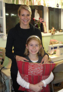 little girl and mom showing a pillow they sewed together