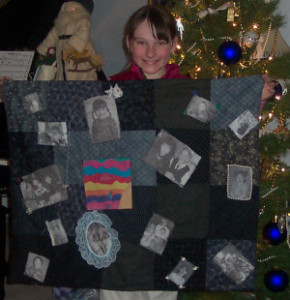 student holding black and white memory quilt